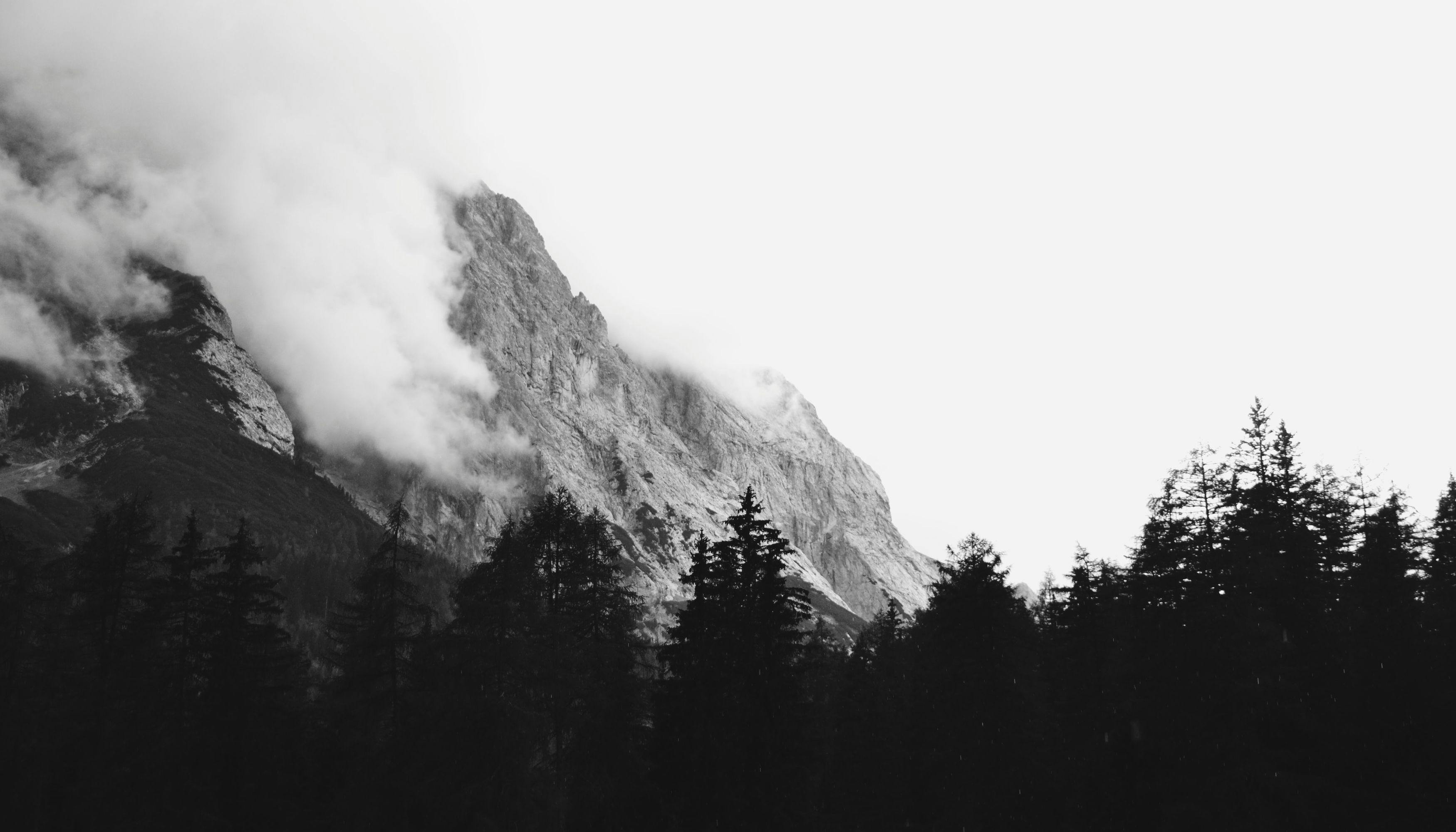 A mountain peeking through clouds